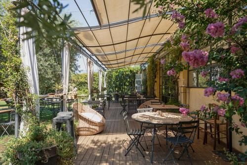 an outdoor patio with tables and chairs and flowers at Castello di Serragiumenta in Firmo