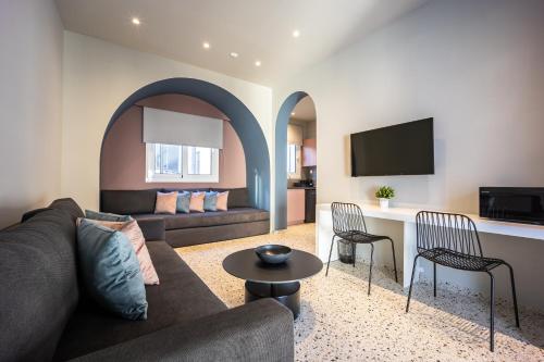 a living room with a couch and a table at Arches Apartments in Athens