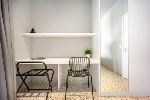 a desk with a chair in a room at Arches Apartments in Athens