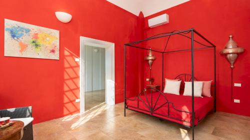 a red bedroom with a red wall with a bed at VILLA LAGUNA 10, Emma VIllas in Faenza