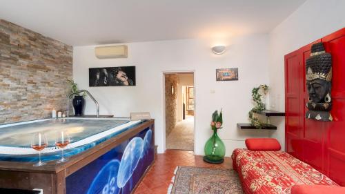 a bathroom with a large tub in the middle of a room at VILLA LAGUNA 10, Emma VIllas in Faenza
