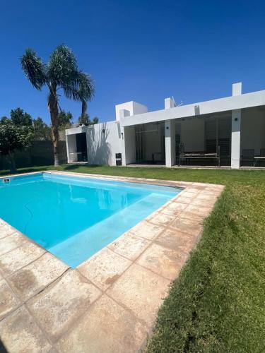 a swimming pool in front of a building at Puyuta beach in Rivadavia