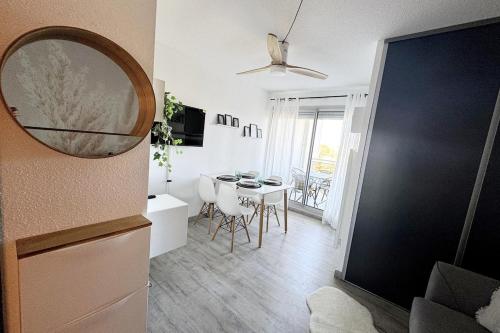 - un salon avec une table et un miroir dans l'établissement Studio, terrasse, wifi, pkg, La Grande Motte, à La Grande Motte