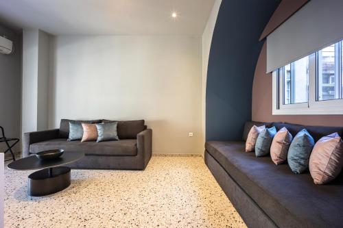 a living room with two couches and a table at Arches Apartments in Athens