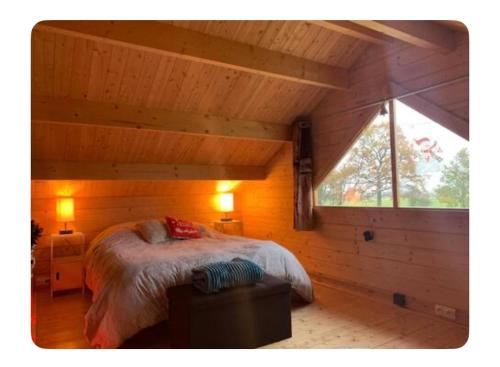En eller flere senge i et værelse på Chalet - Spa Jacuzzi le Rouge-Gorge
