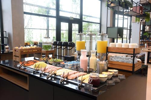 a buffet with many different types of food on a table at ibis Tangará Da Serra in Tangara da Serra