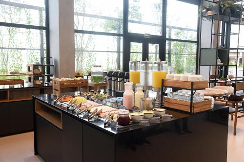 a buffet of food on a table in a room at ibis Tangará Da Serra in Tangara da Serra