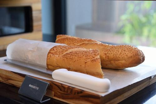 two pieces of bread sitting on a wooden tray at ibis Tangará Da Serra in Tangara da Serra