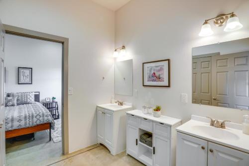 a bathroom with two sinks and a mirror and a bed at Game Day Hub! 1 Mi to AU and Arizona Stadium in Tucson
