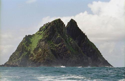 a small mountain in the ocean on the water at Watermark Luxury Accommodation in Portmagee