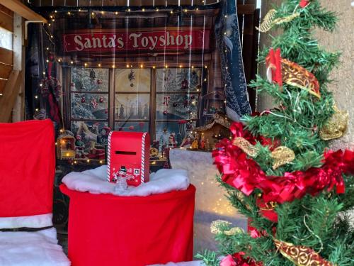 a christmas toy shop with a red truck on display at Gîtelabaronnaise avec piscine chauffée prés parc Asterix in Baron