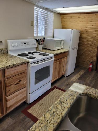 a kitchen with a white stove and a refrigerator at Golden Chalet in Cripple Creek