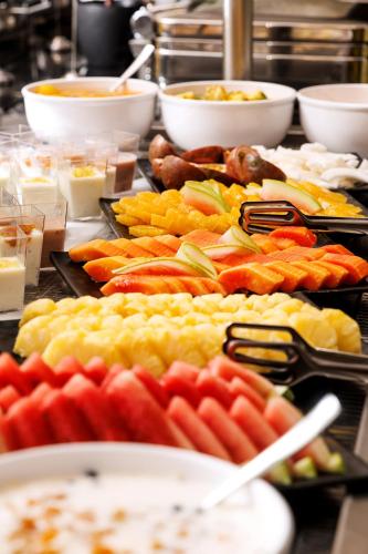 a buffet filled with different types of fruits and vegetables at Riviera Royal Hotel in Conakry