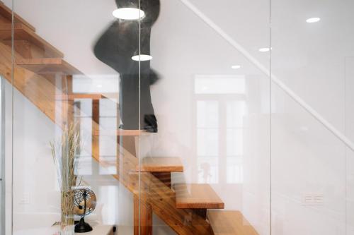 a staircase in a house with a glass wall at San Bernardo, 19 in Avilés
