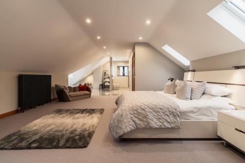 a bedroom with a large bed in a attic at Midways, Stunning Retreat in the Heart of Bowness in Bowness-on-Windermere