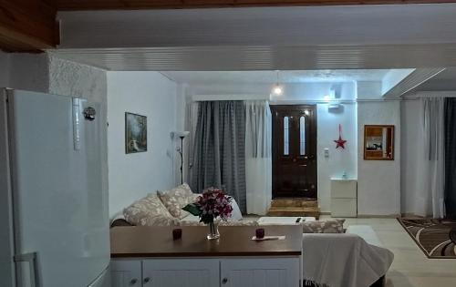 a living room with a couch and a table at Ευρύχωρο και άνετο διαμέρισμα στην Ιτέα Joanna's Apartment in Kírra