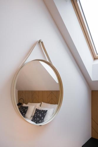 a round mirror hanging on a wall in a room at Chalet Waldzauber Your Alpine Escape in Bad Kleinkirchheim Near the Ski Lift in Bad Kleinkirchheim