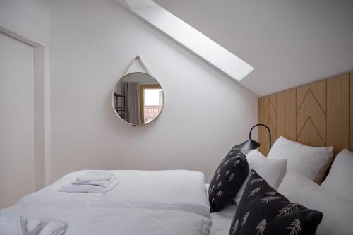 a bedroom with a bed with a mirror on the wall at Chalet Waldzauber Your Alpine Escape in Bad Kleinkirchheim Near the Ski Lift in Bad Kleinkirchheim