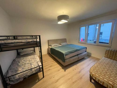 a bedroom with two bunk beds and a window at Big Apartment in Bochum in Bochum
