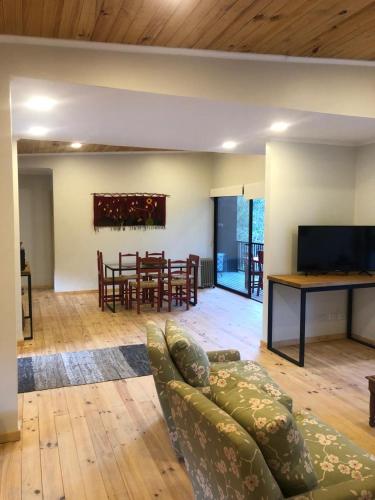 a living room with a couch and a table at Hermosa casa en el bosque in Algarrobo