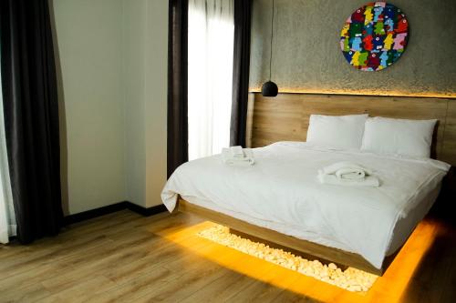 a bedroom with a bed with two towels on it at Glitz Bodrum in Bodrum City