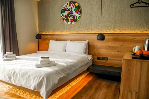 a bedroom with a bed with towels on it at Glitz Bodrum in Bodrum City