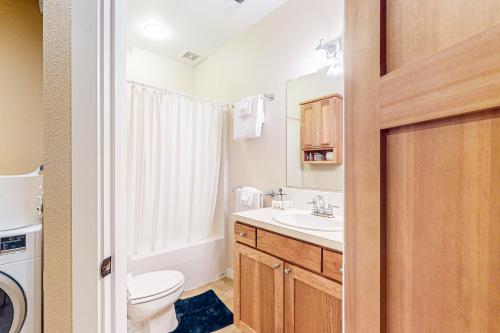 a bathroom with a white toilet and a sink at Hammersley Hideaway in Shelton