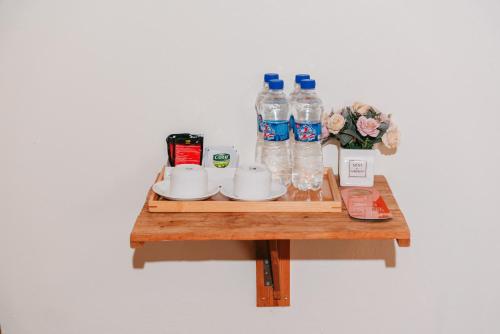 a table with a tray with water bottles on it at Tam Coc Lavender Homestay -Authentic Ninh Binh Experiences in Ninh Binh
