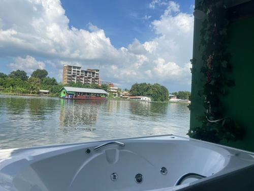 a bath tub sitting in the middle of a river at KeanKan Resort in Ban Chuk Kum