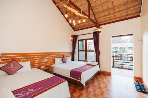 a bedroom with two beds and a window at Tam Coc Lavender Homestay -Authentic Ninh Binh Experiences in Ninh Binh