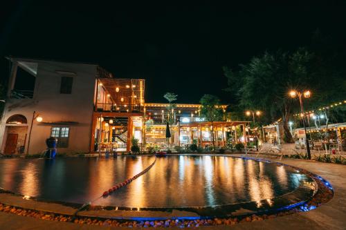 a night view of a large fountain in the middle of a street at Tam Coc Lavender Homestay -Authentic Ninh Binh Experiences in Ninh Binh
