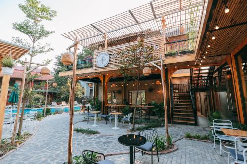 a building with a patio with tables and chairs at Tam Coc Lavender Homestay -Authentic Ninh Binh Experiences in Ninh Binh