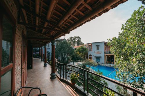 a balcony with a view of a swimming pool at Tam Coc Lavender Homestay -Authentic Ninh Binh Experiences in Ninh Binh