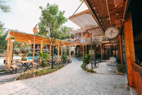 a patio with tables and chairs in a building at Tam Coc Lavender Homestay -Authentic Ninh Binh Experiences in Ninh Binh