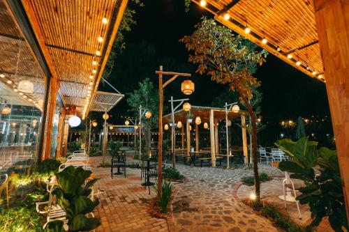 a patio with chairs and lights at night at Tam Coc Lavender Homestay -Authentic Ninh Binh Experiences in Ninh Binh