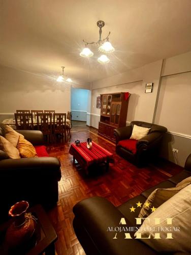 a living room with two couches and a table at El Hogar - Sucursal Calle Julio Mendez y Obispo Anaya con Garaje cubierta in Cochabamba