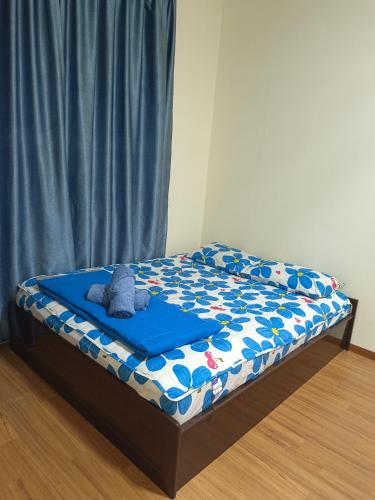 a bed with a teddy bear on top of it at Seaview Emerald Sandakan in Sandakan
