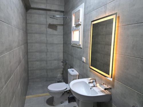 a bathroom with a toilet and a sink at New Cairo Cozy Studio استديو فندقى بالتجمع in New cairo