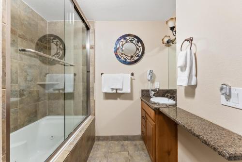 a bathroom with a shower and a tub and a sink at Great Location, 2BR, Close to Lifts & Restaurants, Fireplace in Park City