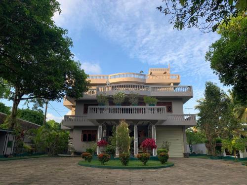 a large house with a balcony on top of it at Sagarika Beach Hotel in Moragalla