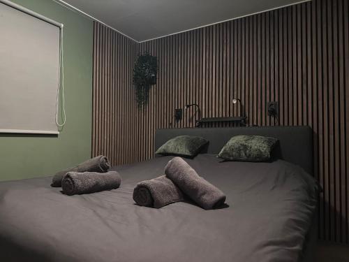 a bedroom with a bed with two stuffed animals on it at Heerlijk chalet midden in de natuur in Putten