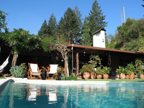 a house with a swimming pool in front of a house at Casa Dos Canais, River Cottage in Marco de Canaveses