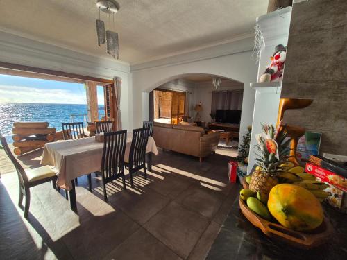 a living room with a table and a view of the ocean at Marquise & Infinity villas in Glacis