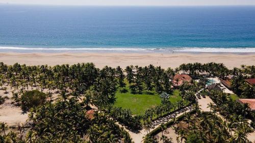 an aerial view of a resort with the ocean at Puertas Paraíso Hotel boutique in Zihuatanejo