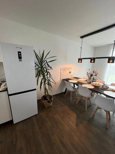 a kitchen and dining room with a table and a plant at Domek Prosetin244 in Prosetín