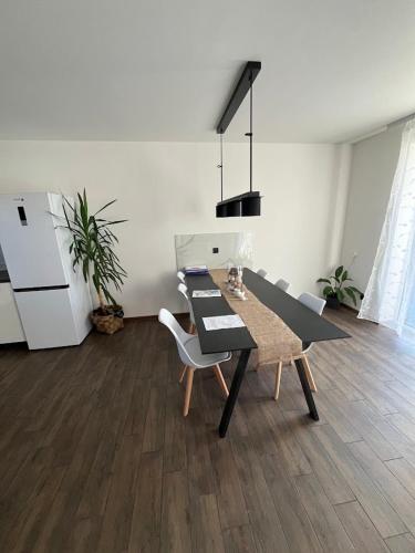 a dining room with a black table and chairs at Domek Prosetin244 in Prosetín