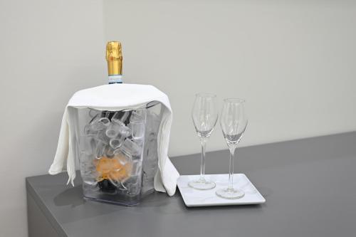 a bottle of wine and two glasses on a table at Hotel Hypnos in San Giorgio Montagna