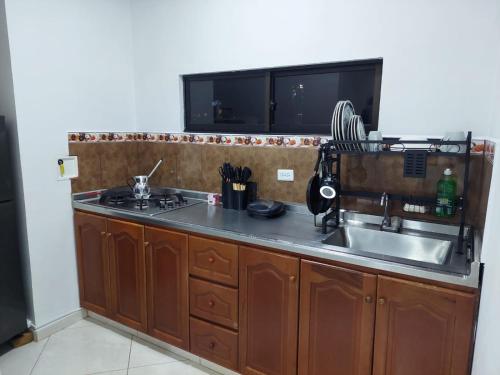 a kitchen with a sink and a counter top at San Antonio in El Peñol
