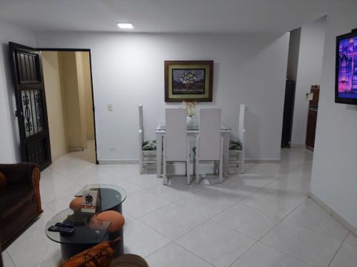 a living room with a table and chairs at San Antonio in El Peñol
