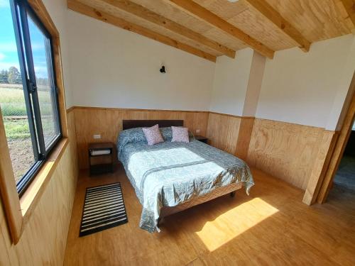 Un pat sau paturi într-o cameră la Refugio Tringlo